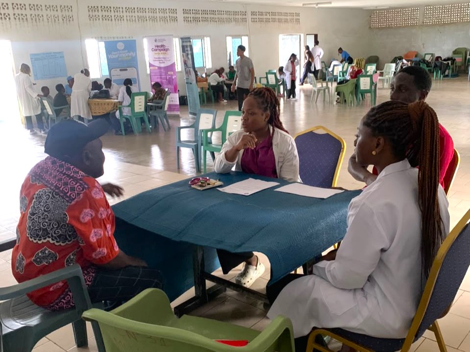 Doctor giving a free medical consultation to a patient in Mokundange, Cameroon